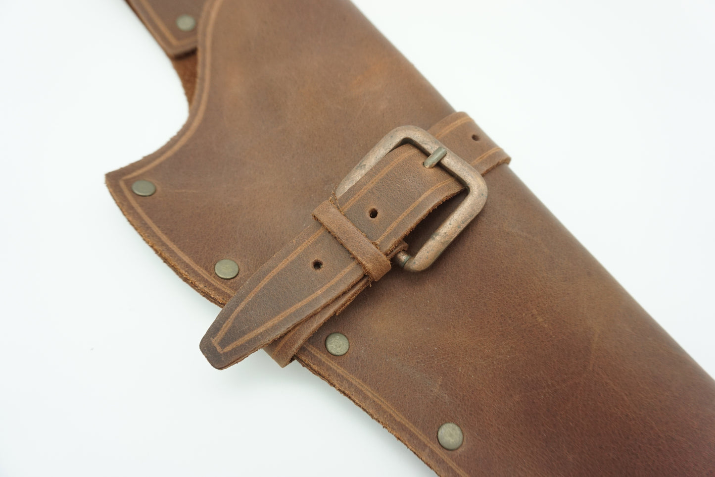 close up of leather colt revolver holster with brass buckle