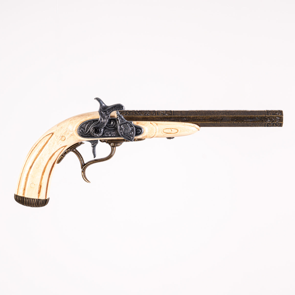 right hand side of flintlock showing the flintlock mechanism, brass octagonal barrel and faux ivory grip.