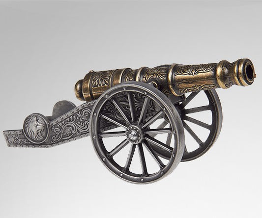 Image ofr small ornate brass cannon on silver wheels and an ornate base.