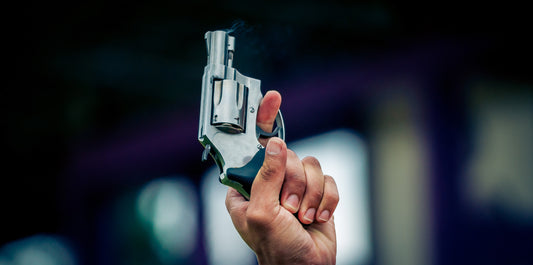 Hand holding up a blank startert pistol