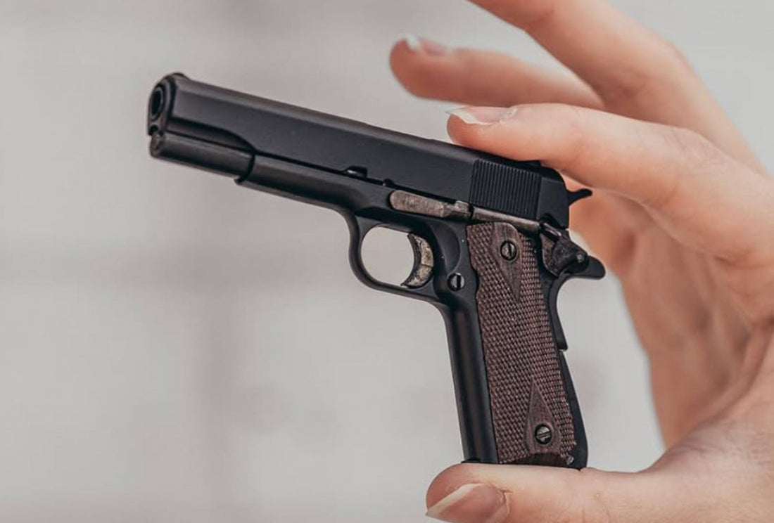 close view of a hand carrying miniature gun