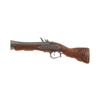 Left side view of replica 18th Century Blunderbuss with carved wood handle and decorative trigger guard, trigger, hammer, frizzen, and barrel. 