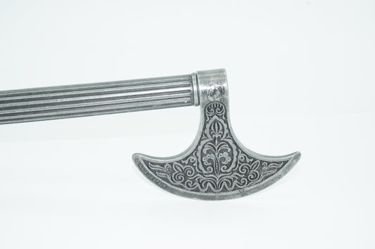 Side close-up view of metal ottoman pistol axe showing detailed carving on axe head.