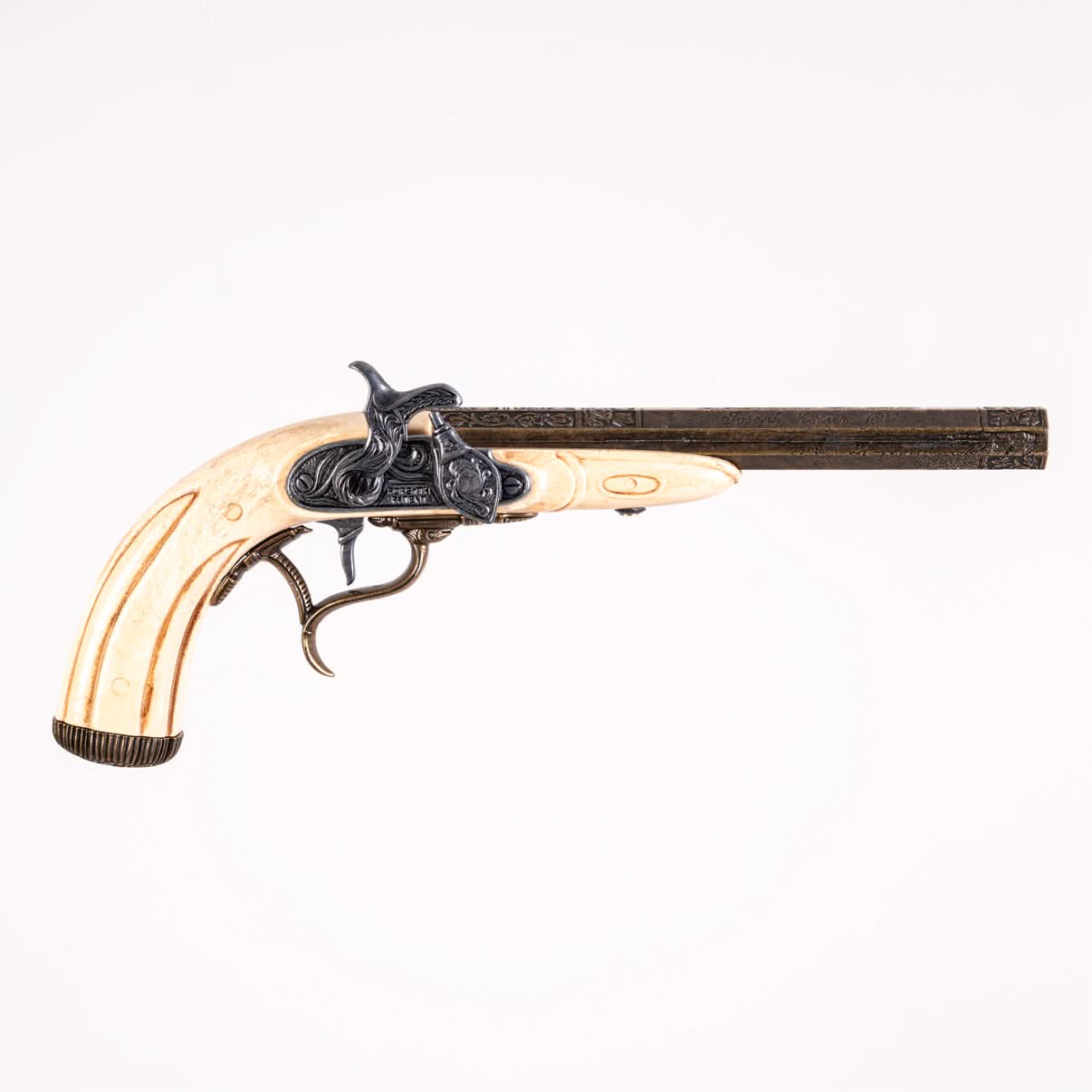 right hand side of flintlock showing the flintlock mechanism, brass octagonal barrel and faux ivory grip. 