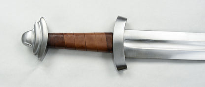 Closeup of acorn pommel and leather wrapping on sword.