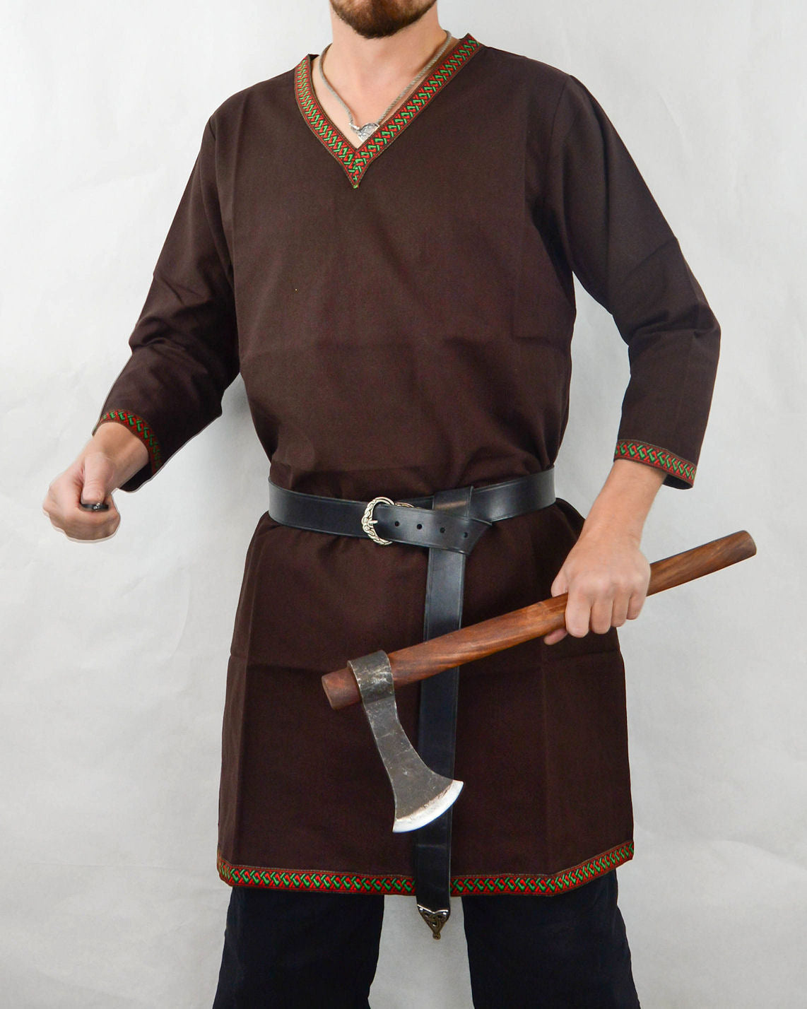 male model wearing a brown Viking Tunic  and holding an ax
