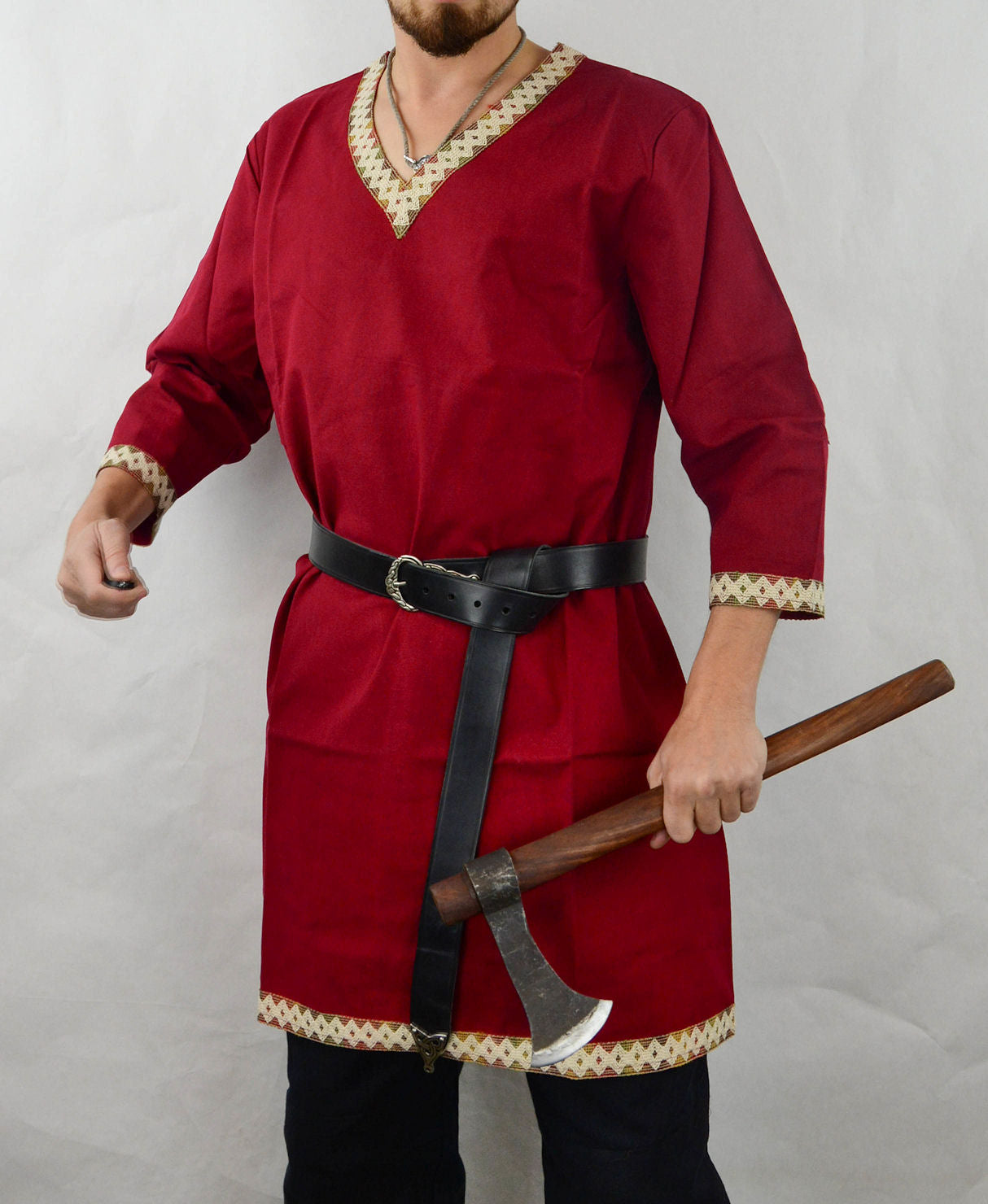 male model wearing a red Viking Tunic and holding an ax