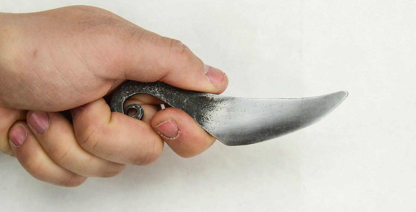 a hand holding the Viking Neck Knife